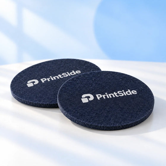 Round navy felt coasters with PrintSide logos.