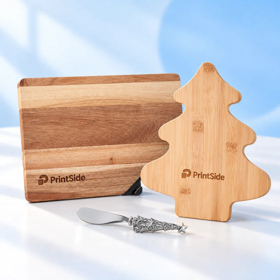 Rectangular wooden board and tree-shaped bamboo cheese board with PrintSide logos.