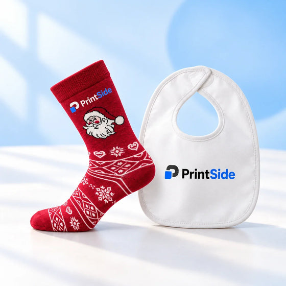 Red festive sock and white baby bib with PrintSide branding.