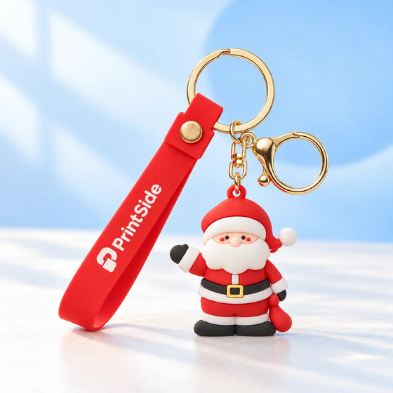 Santa keyring with a red PrintSide wrist strap and gold-tone rings.
