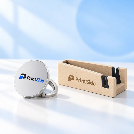 Silver phone grip and wooden phone stand with PrintSide logos.