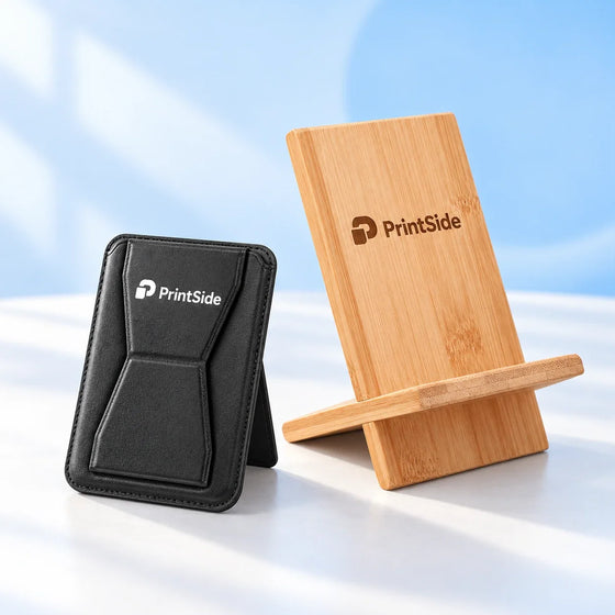 Black phone wallet and bamboo phone stand with PrintSide logos.