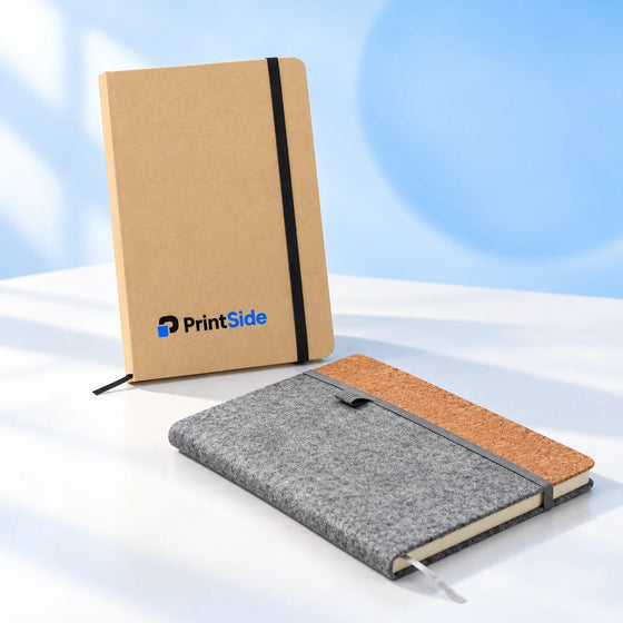 Kraft and felt-and-cork notebooks with PrintSide branding.