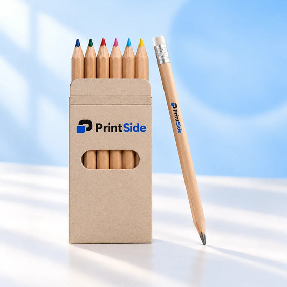 Coloured pencils in a kraft sleeve beside a wooden graphite pencil with a white eraser, with PrintSide branding.