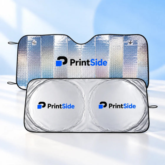 Two silver reflective car windscreen sunshades with black edges and PrintSide logos.