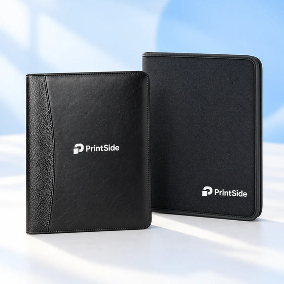 Textured black portfolio and black zipped conference folder with PrintSide logos.