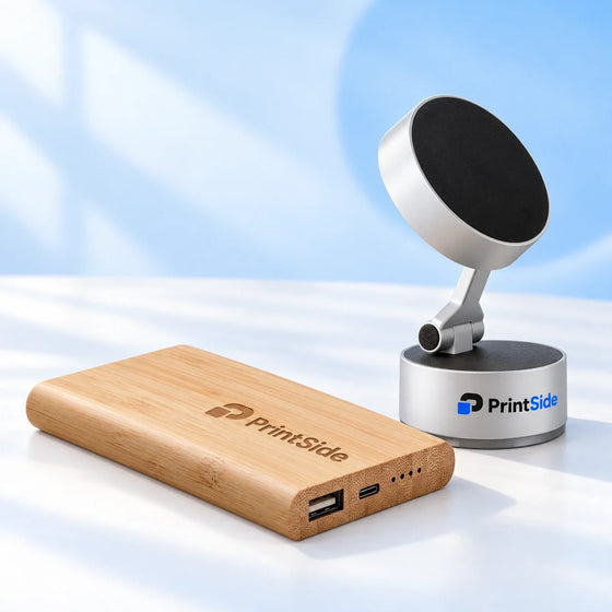 Bamboo power bank and silver phone holder with PrintSide logos.