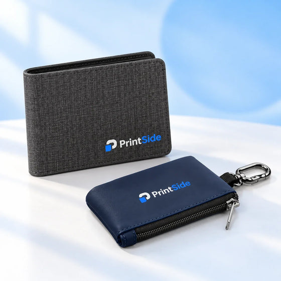 Charcoal wallet and navy zip pouch with a clip and PrintSide logos.